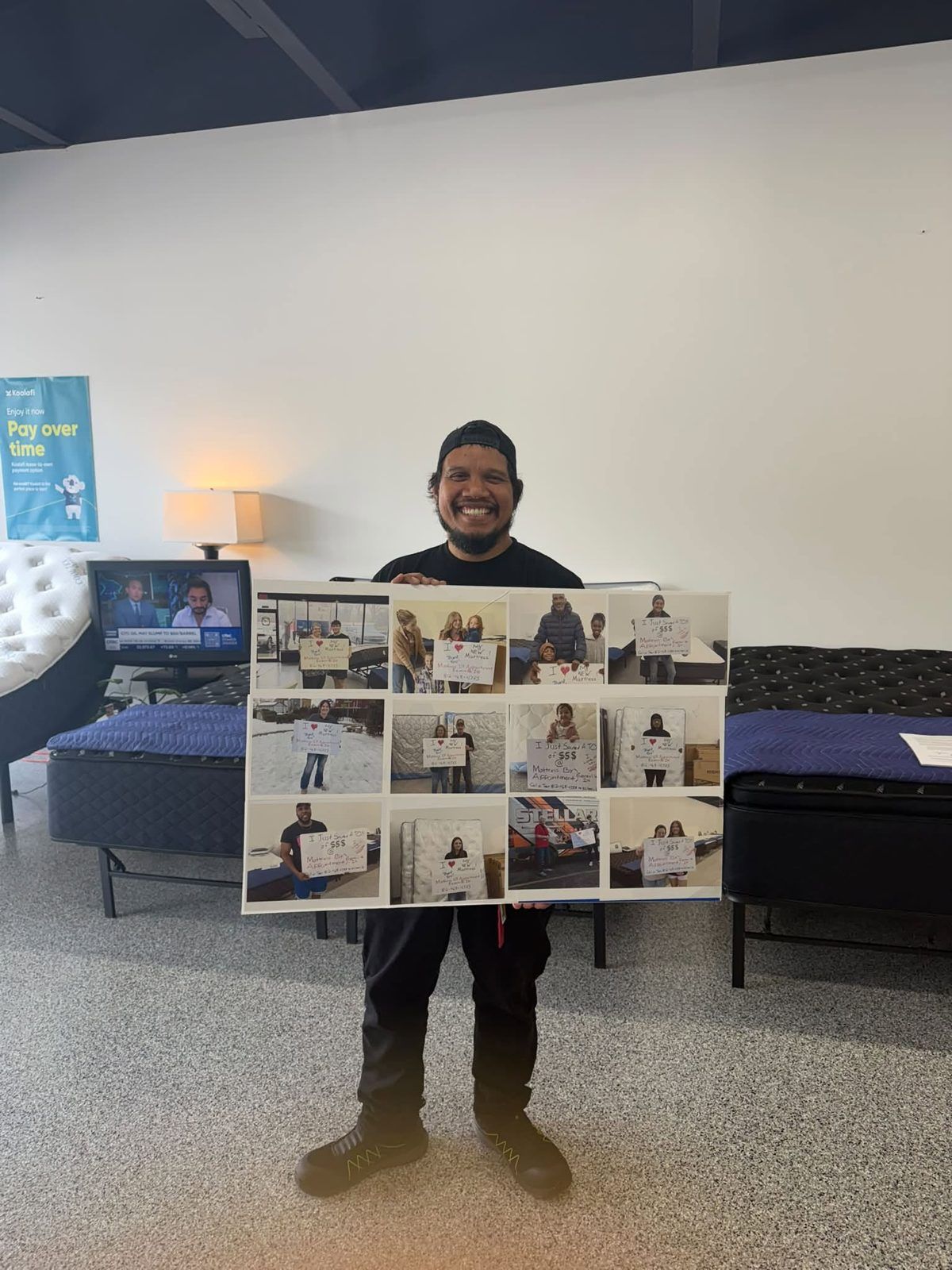 Customer in the showroom holding a board of customer photos
