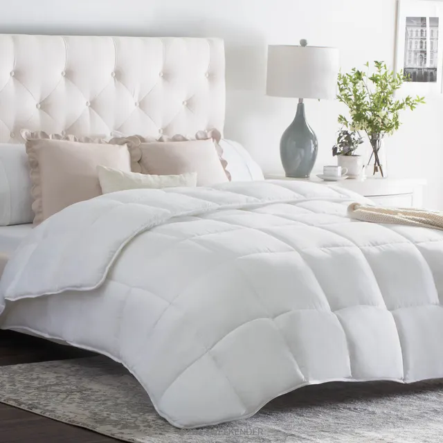 White box-stitched down-alternative comforter on a bed