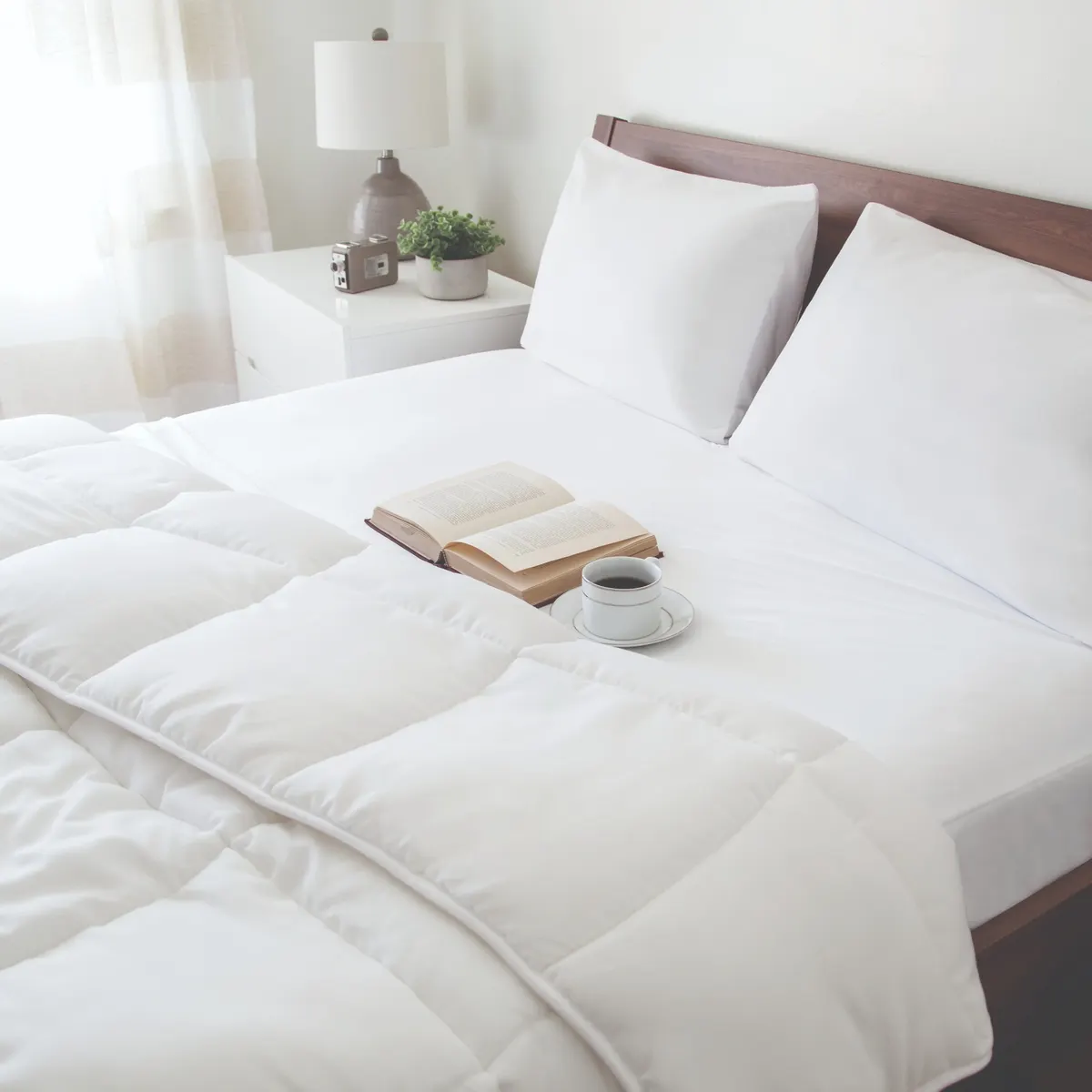 Weekender jersey mattress protector shown with white bedding