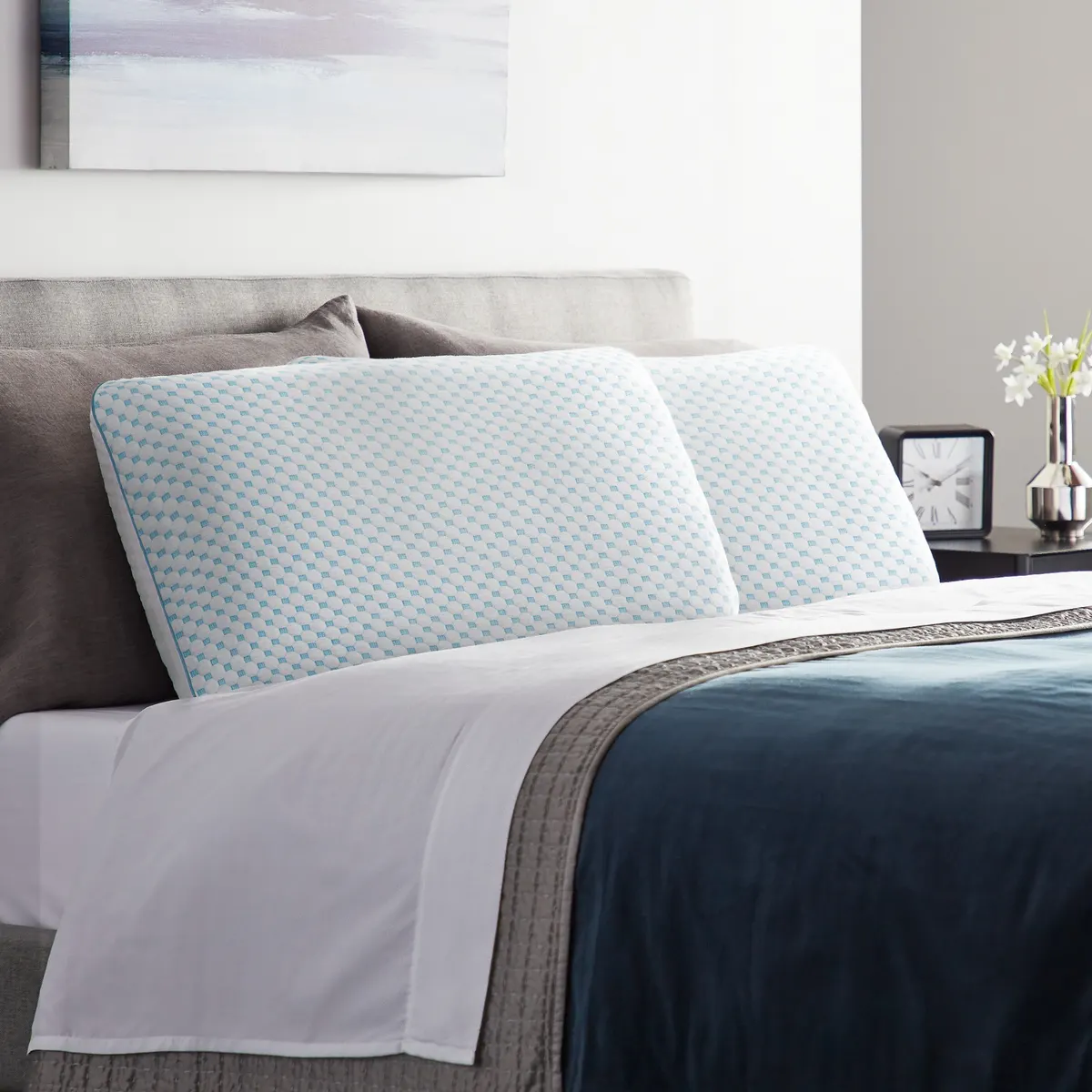 Two Weekender gel memory foam pillows with patterned cooling covers on a made bed